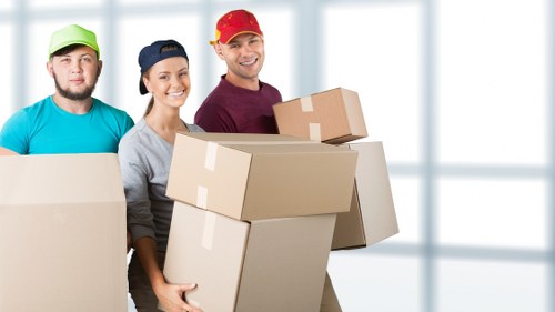 Professional movers loading furniture into a van