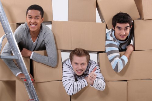 Professional movers handling desks and office items carefully